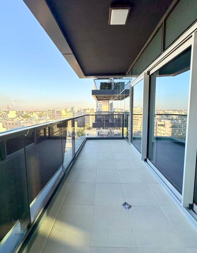 Spacious balcony with panoramic city views in ICE Tel Aviv apartment