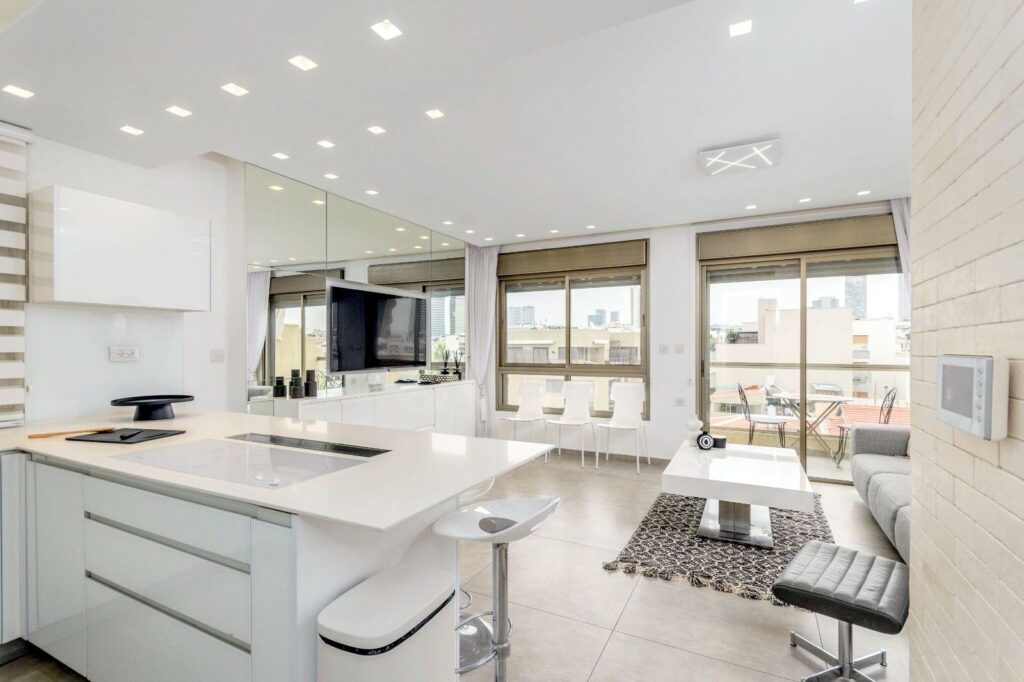 Renovated Tel Aviv property near the beach, offering 75 sqm of living space, balconies, and modern amenities.