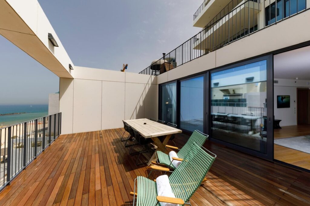 Spacious sea-view balcony in Tel Aviv apartment at Renoma, with Mediterranean backdrop