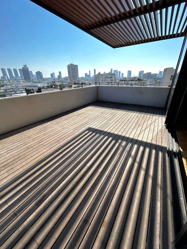 Spacious 30 Sqm balcony in a duplex penthouse, offering panoramic views of Tel Aviv near Frishman Beach.