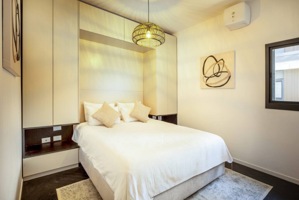 Cozy bedroom with built-in closets in Tel Aviv rental apartment