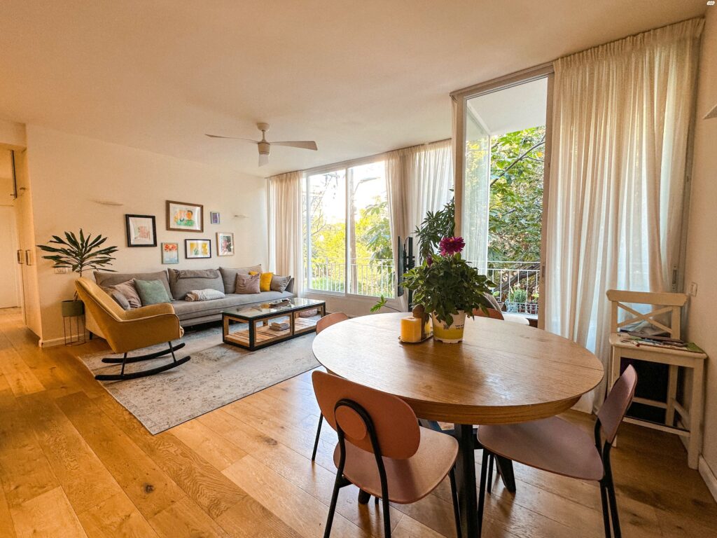 Renovated Tel Aviv living room with balcony and dining area