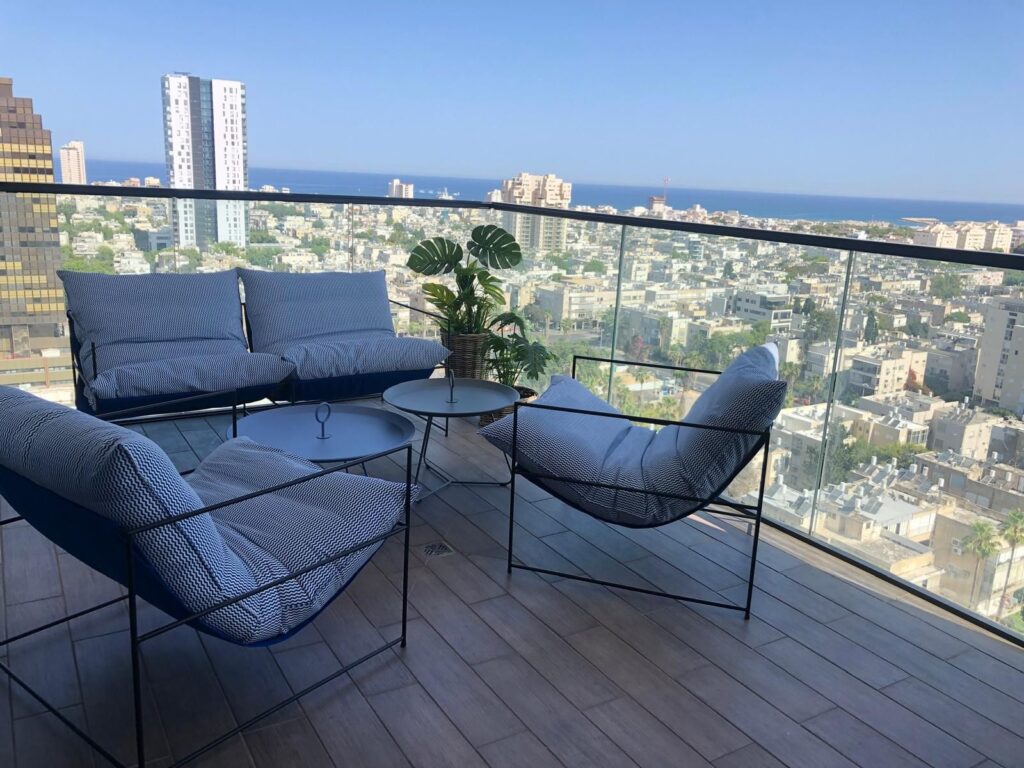 Balcony with sea view and outdoor seating in Tel Aviv apartment