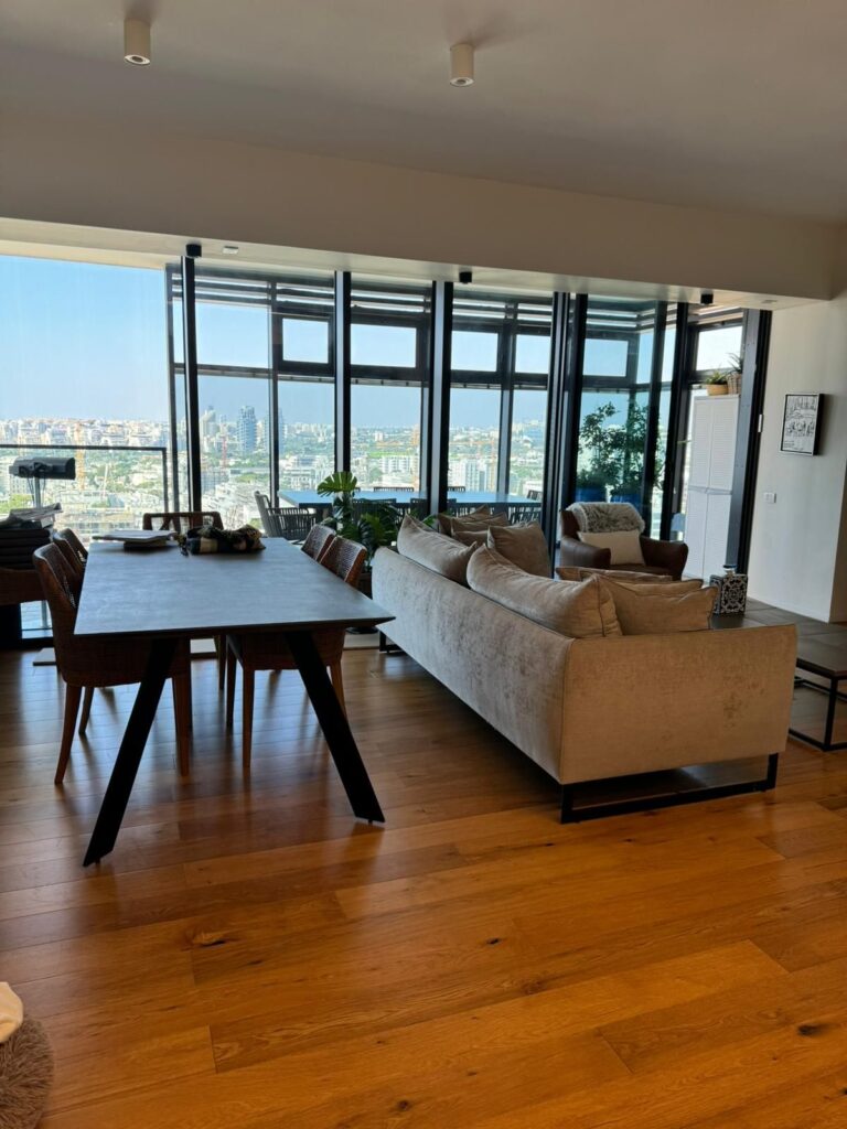 Open living and dining area with sea view in luxury Tel Aviv apartment