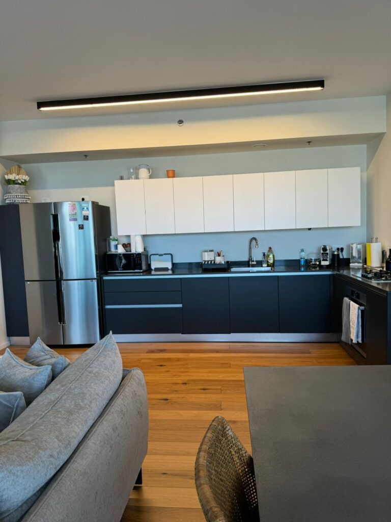 Stylish open kitchen with modern appliances in Tel Aviv apartment