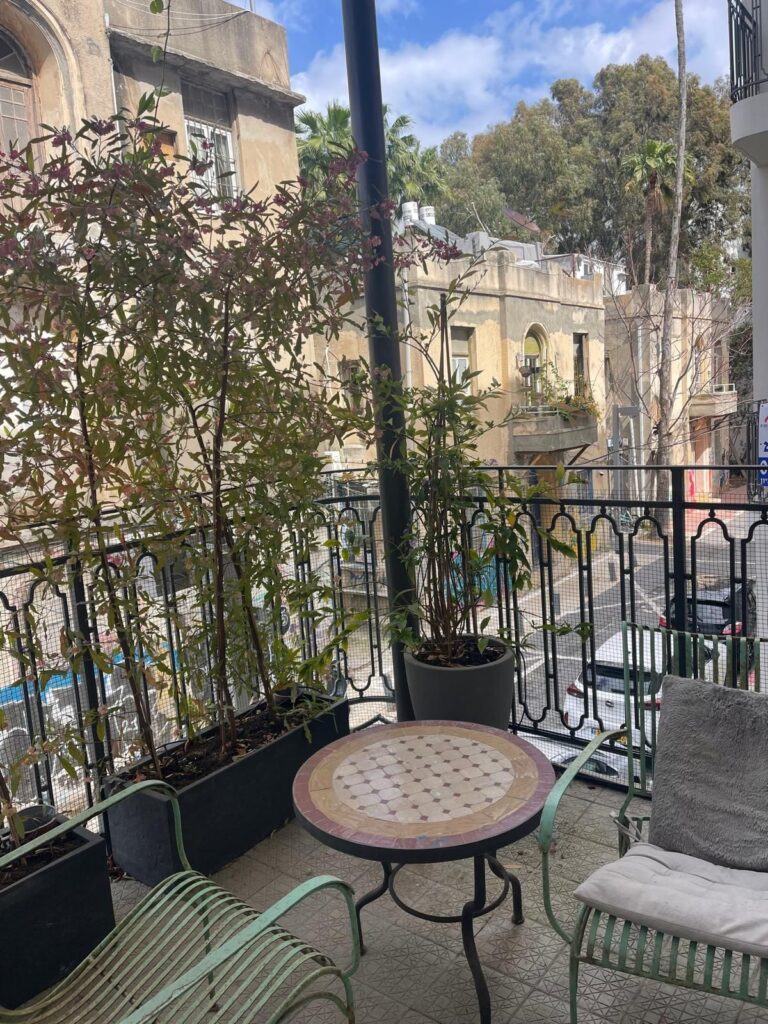 Balcony with greenery and city street view in Tel Aviv