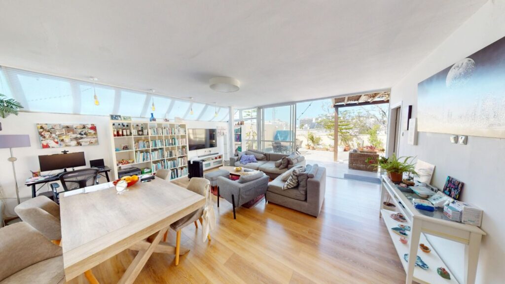 Open living and dining room in Gordon Beach penthouse for sale
