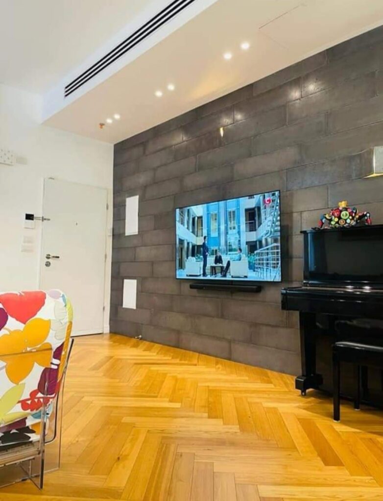 Stylish modern living space with TV and piano in Tel Aviv home