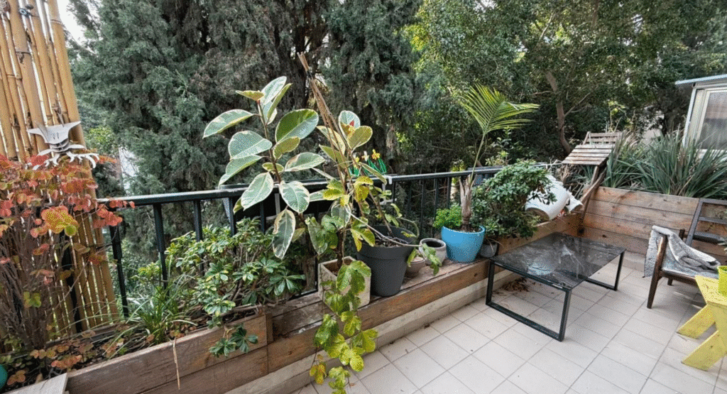 Private balcony with lush greenery in central Tel Aviv apartment