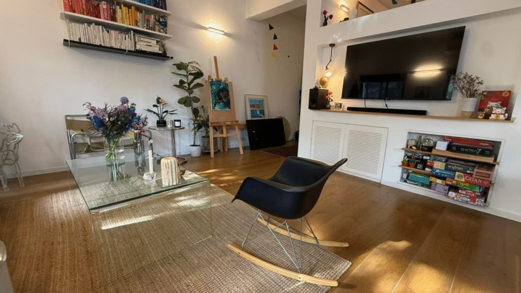 Architect-renovated living area with built-in shelving and TV unit in Tel Aviv flat