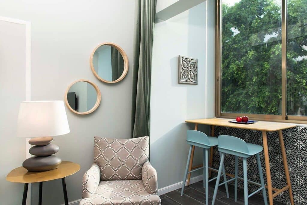 Cozy corner with armchair, breakfast bar and large window in Tel Aviv apartment