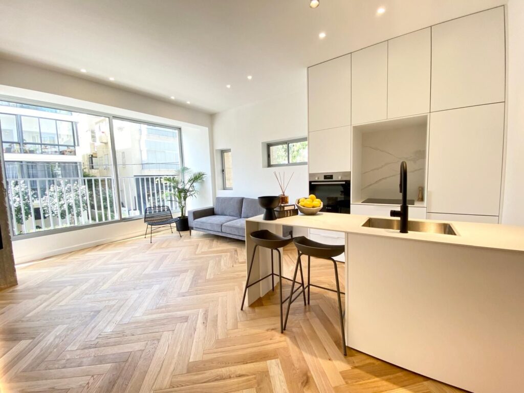 Bright living area with modern kitchen in Tel Aviv apartment for sale