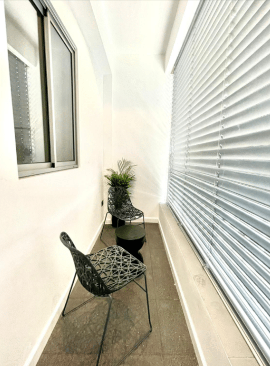Cozy balcony with seating area in apartment for sale in Tel Aviv