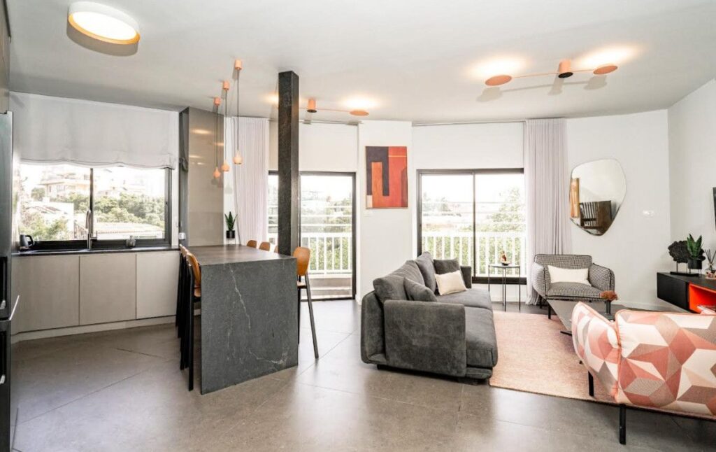 Spacious modern living area with open kitchen and large windows