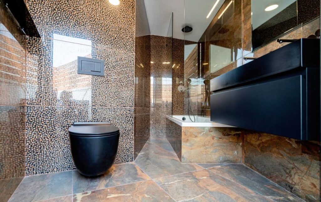 Luxury bathroom with mosaic tile wall and black fixtures