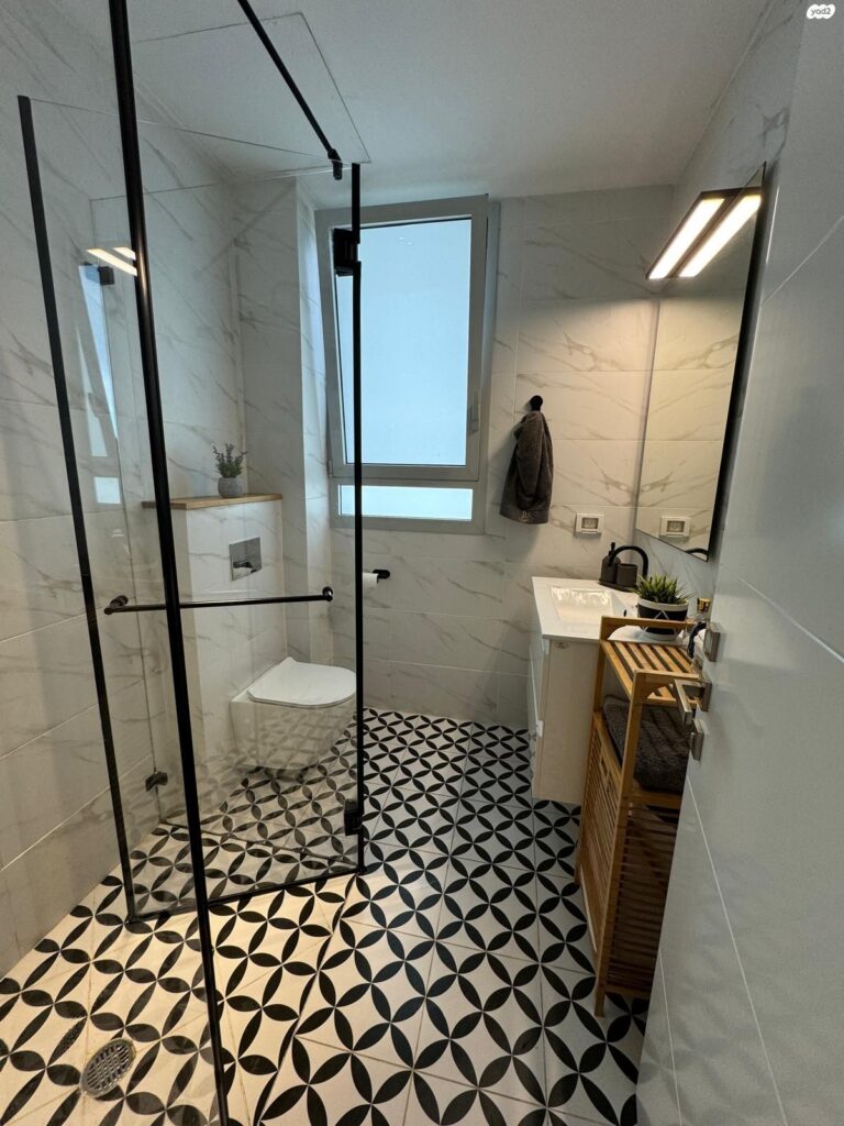 Designer bathroom with walk-in shower and black fixtures
