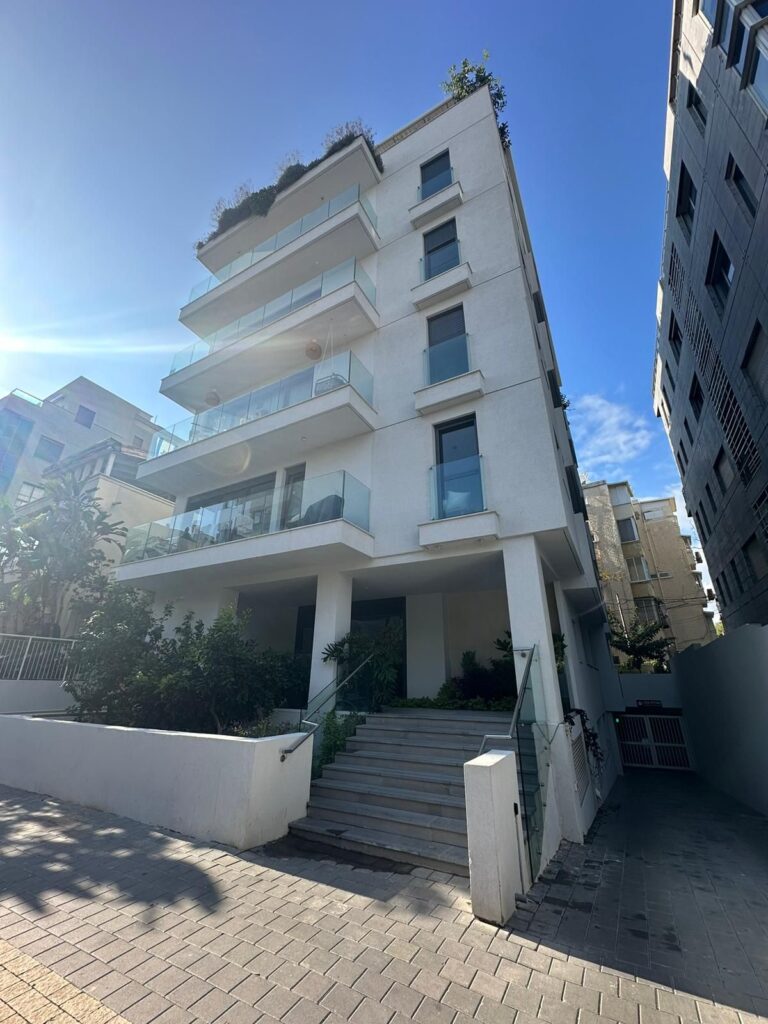 Contemporary white building with balconies near Hilton Tel Aviv