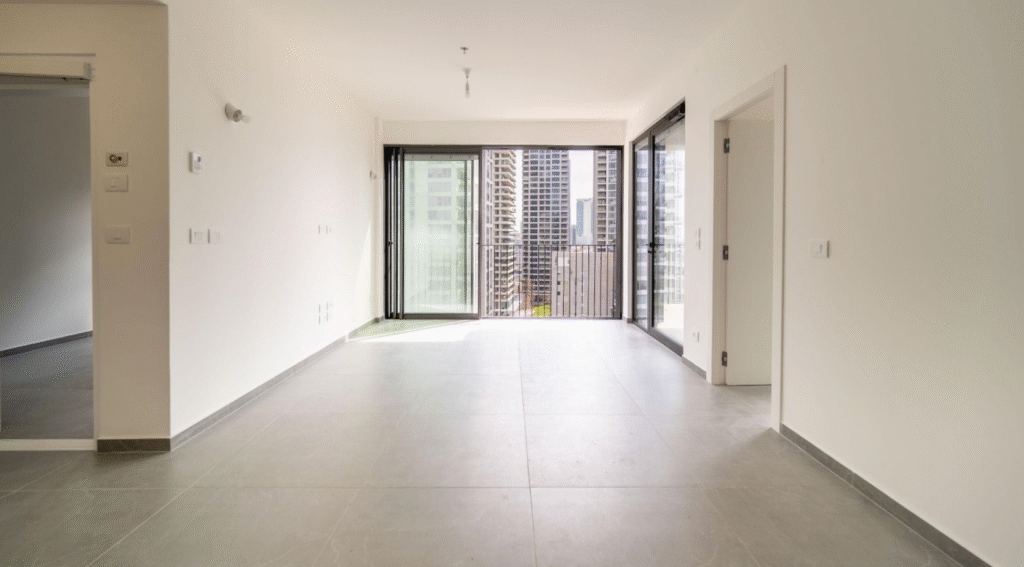 Open-plan living space with balcony access and panoramic windows