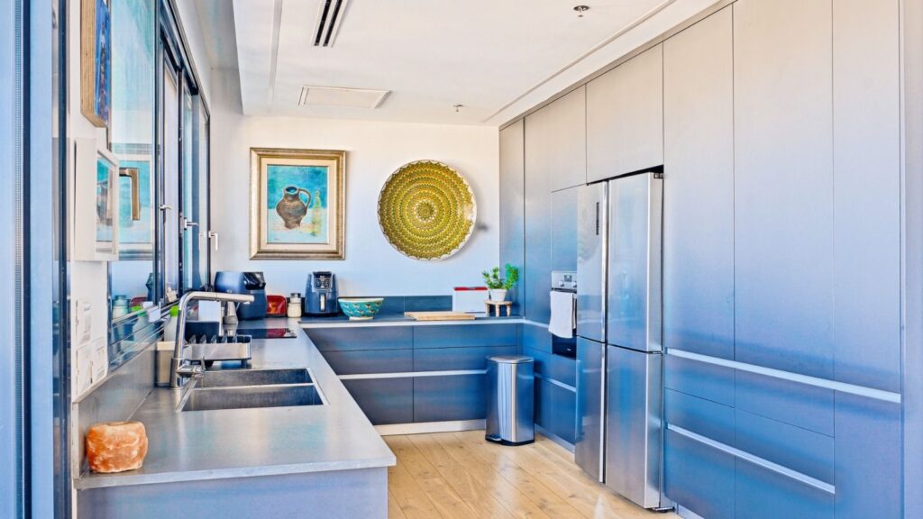 Sleek modern kitchen with built-in cabinetry in Tel Aviv penthouse