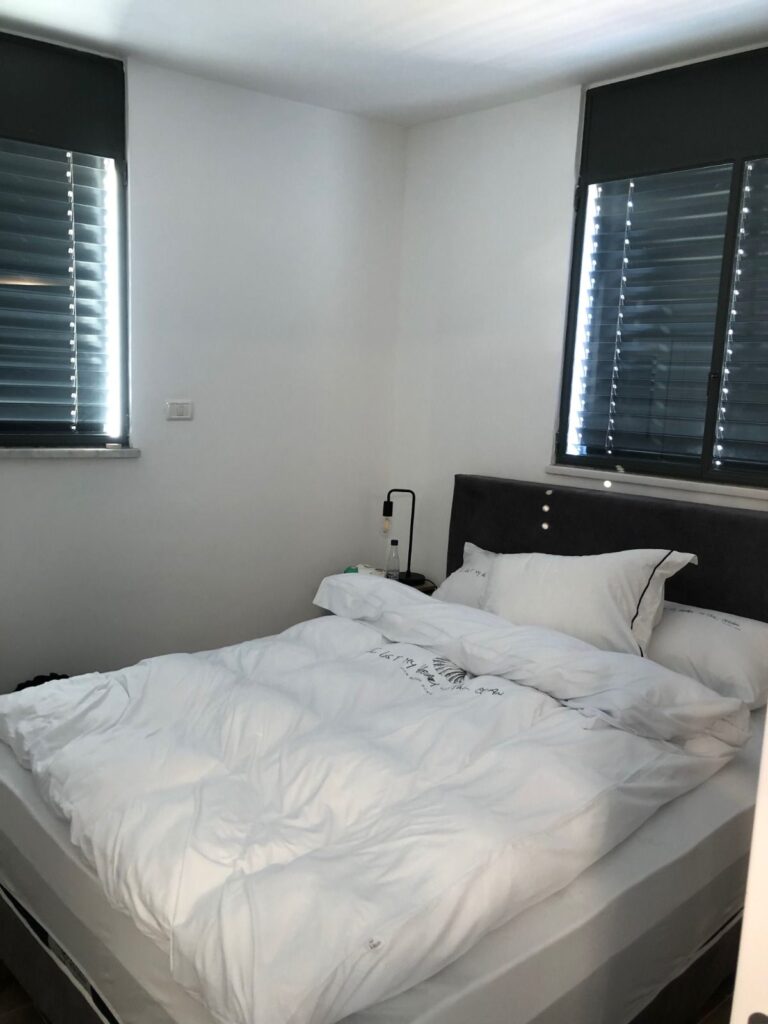 Cozy bedroom with double bed and blackout blinds
