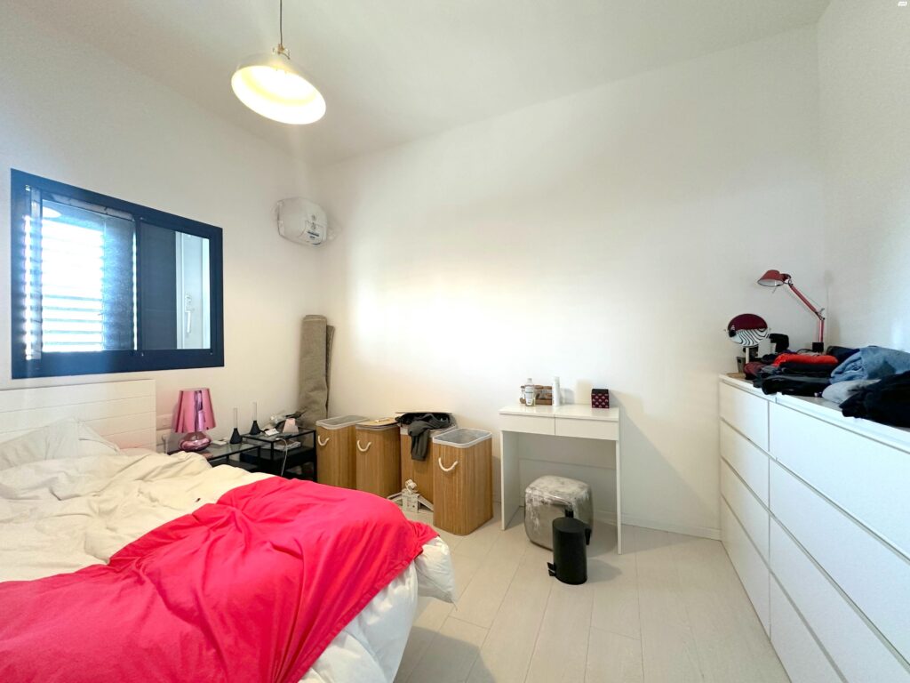 Bright minimalist bedroom in Tel Aviv apartment