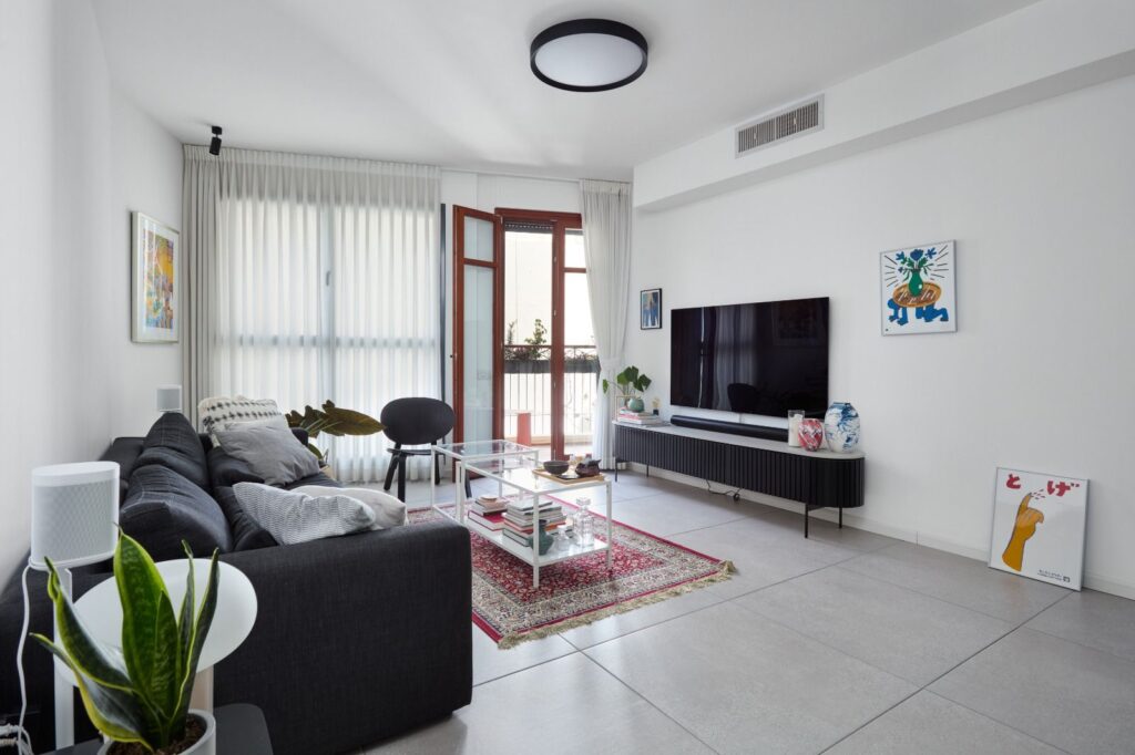 Bright living room with balcony access in Tel Aviv apartment
