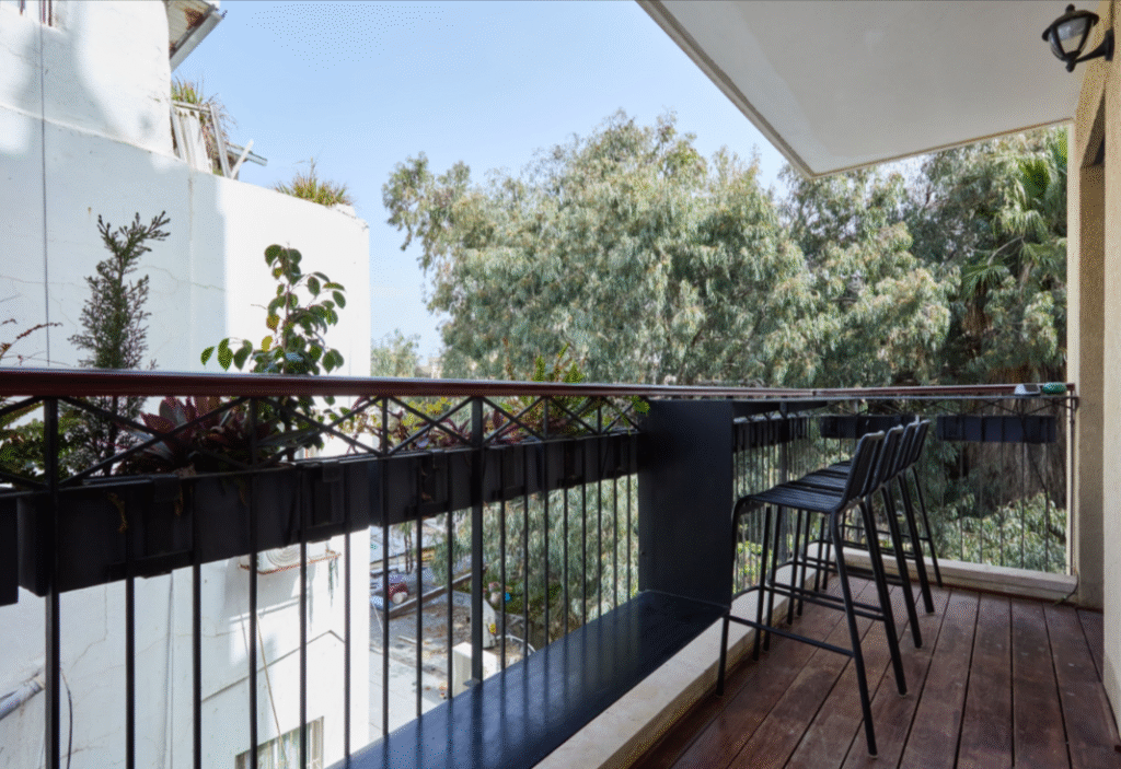 Rear-facing balcony with lush views in Tel Aviv apartment
