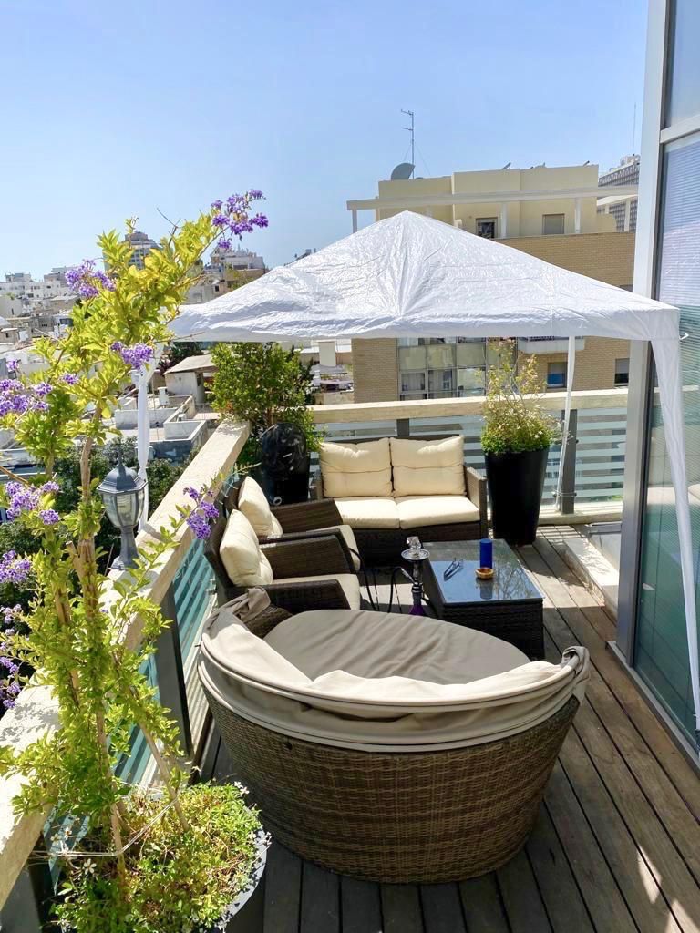 Large west-facing balcony with lounge seating and canopy