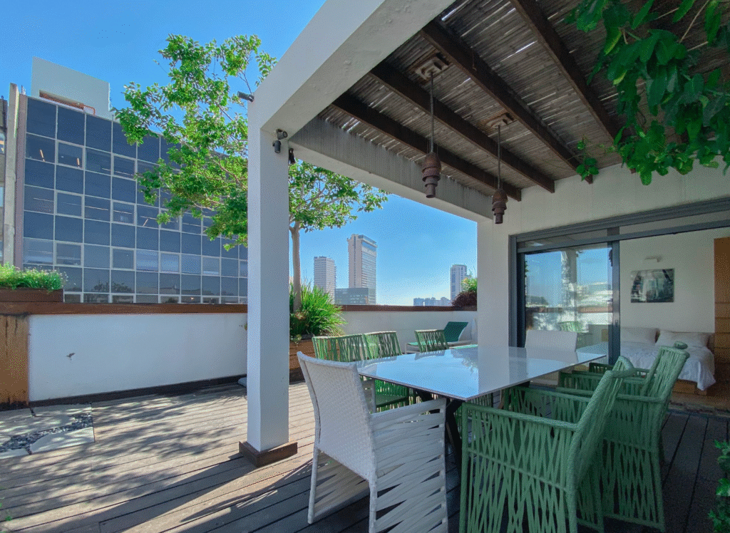 Tel Aviv penthouse terrace with dining area and skyline view