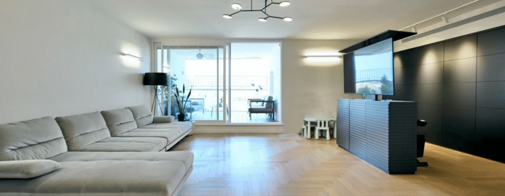 Spacious living room with custom wood flooring and natural light