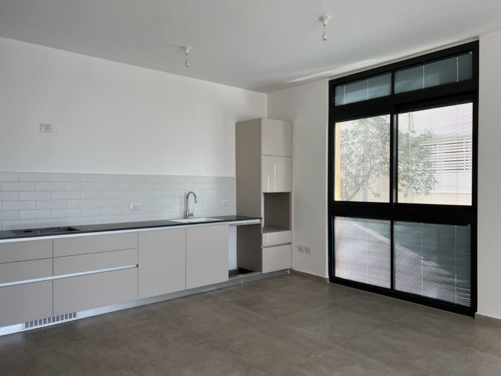 Modern kitchen with large window in new Tel Aviv apartment