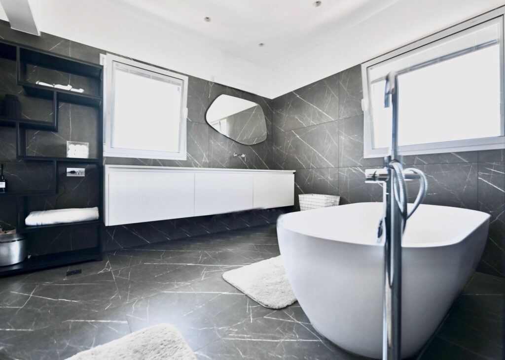 Luxury main bathroom with free-standing tub and marble tiles
