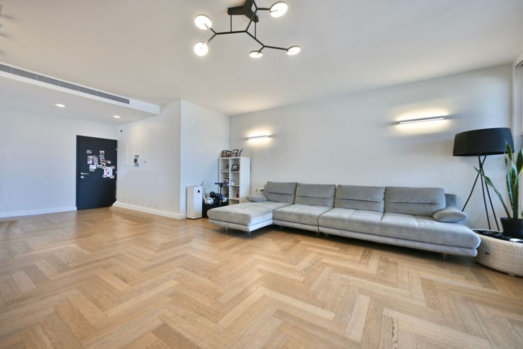 Spacious living room with custom wood flooring and natural light