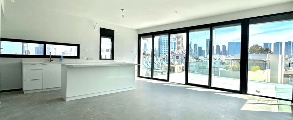 Open-plan kitchen with skyline view in new Tel Aviv penthouse