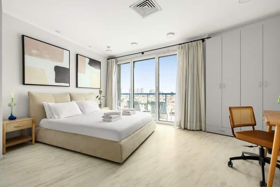 Bright master bedroom with balcony and sea view in Tel Aviv short term rental