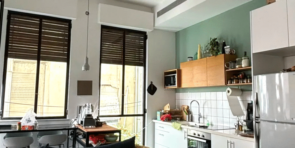 Open-plan kitchen and dining space with modern finishes in Tel Aviv home
