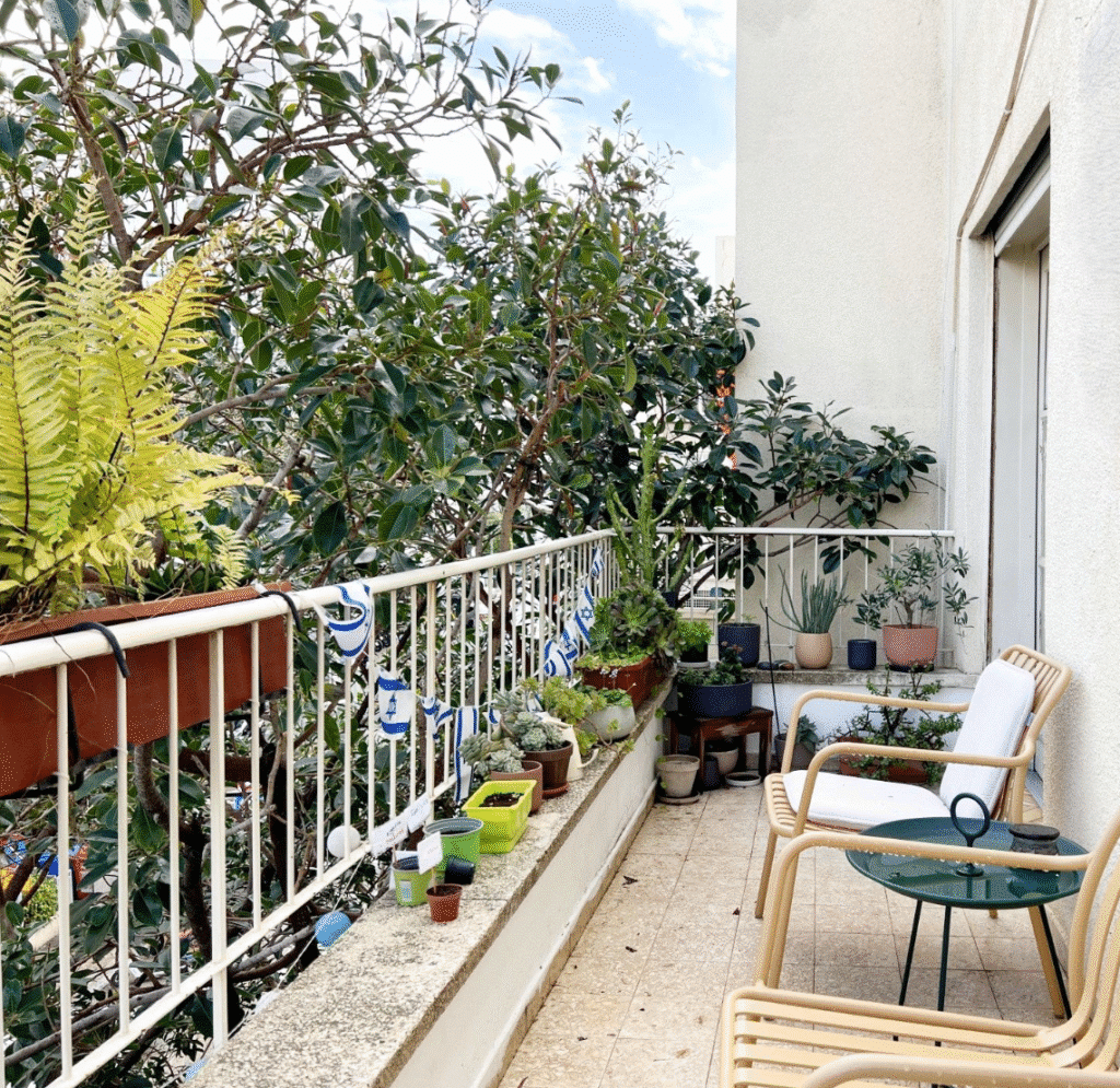 Balcony with greenery and patio furniture in Tel Aviv apartment