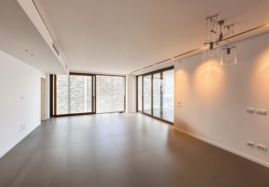 Modern living room with large sliding glass doors in luxury Tel Aviv apartment