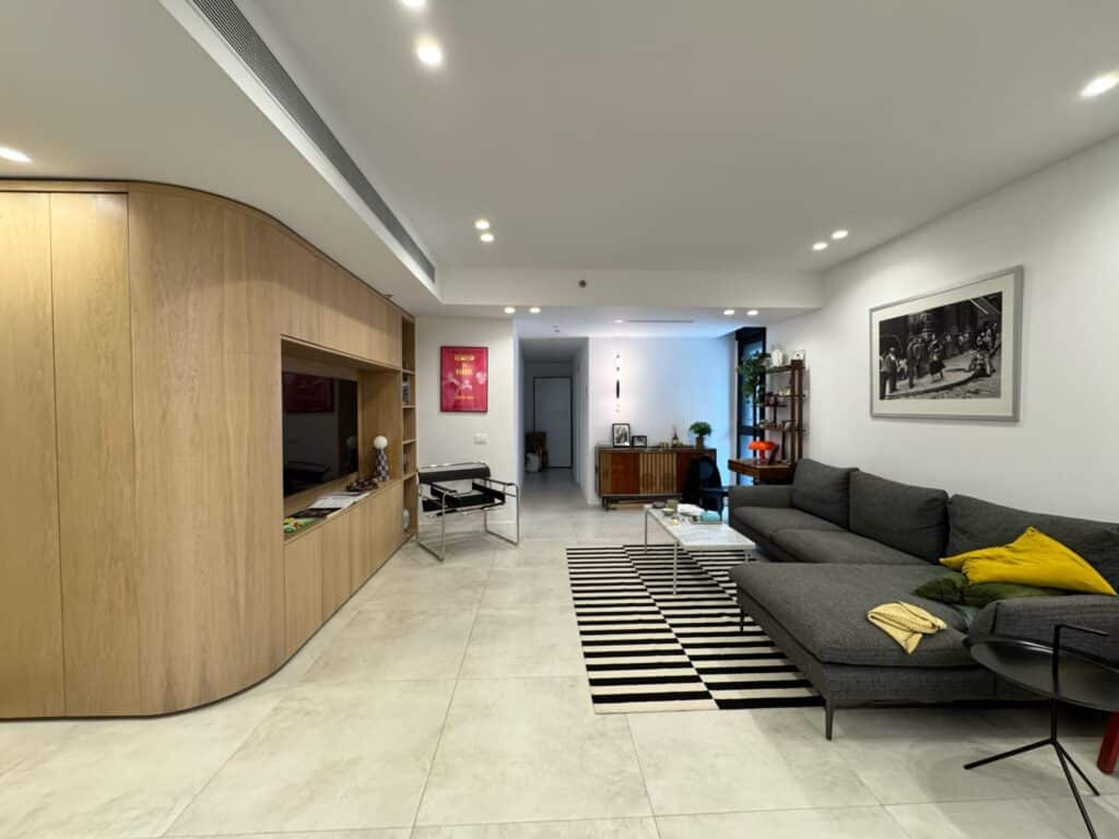 Spacious and stylish living room with wood paneling in Tel Aviv apartment