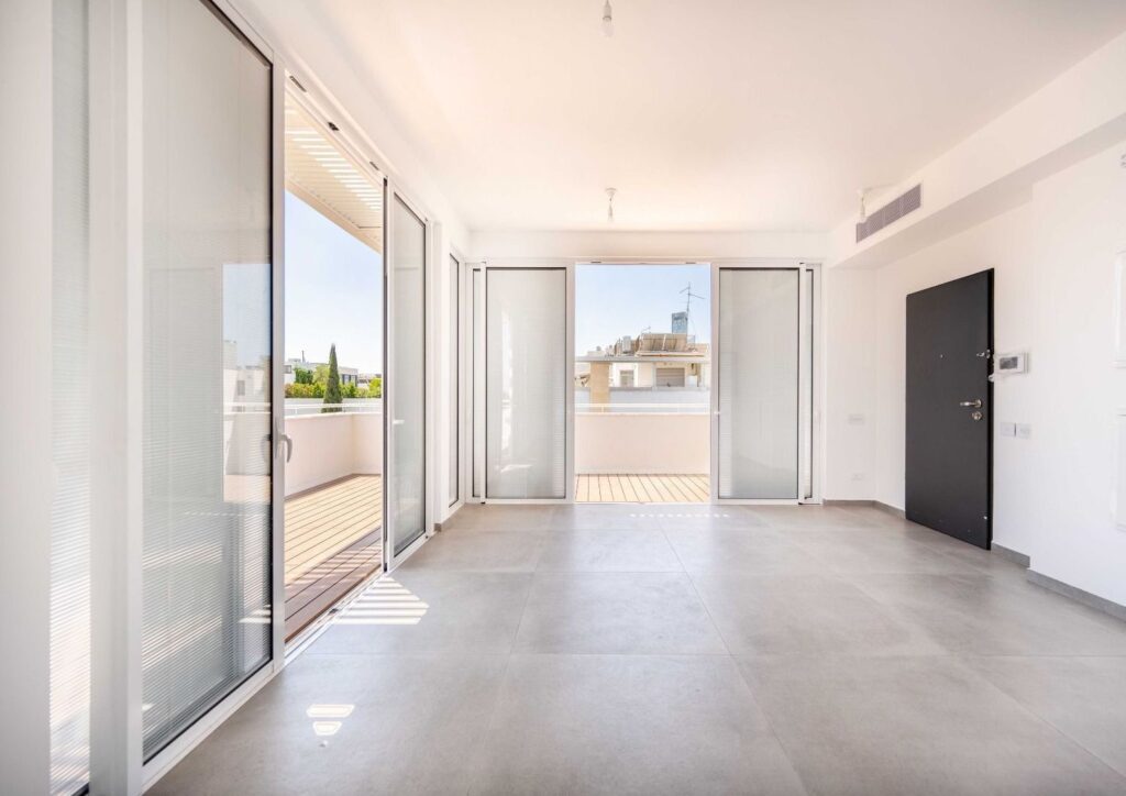 Large bedroom with floor-to-ceiling windows and outdoor access