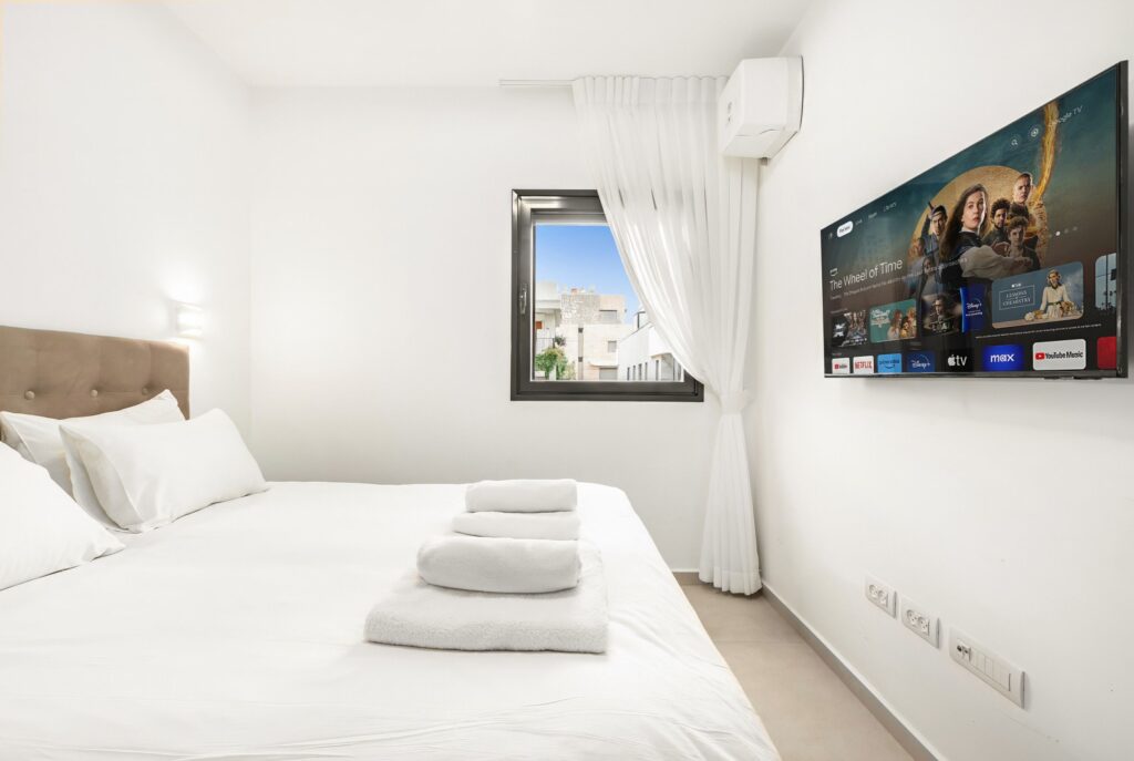 Guest bedroom with modern decor and smart TV