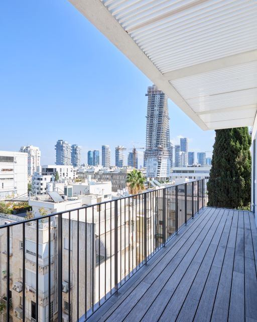 Balcony overlooking city skyline near Kikar HaMedina