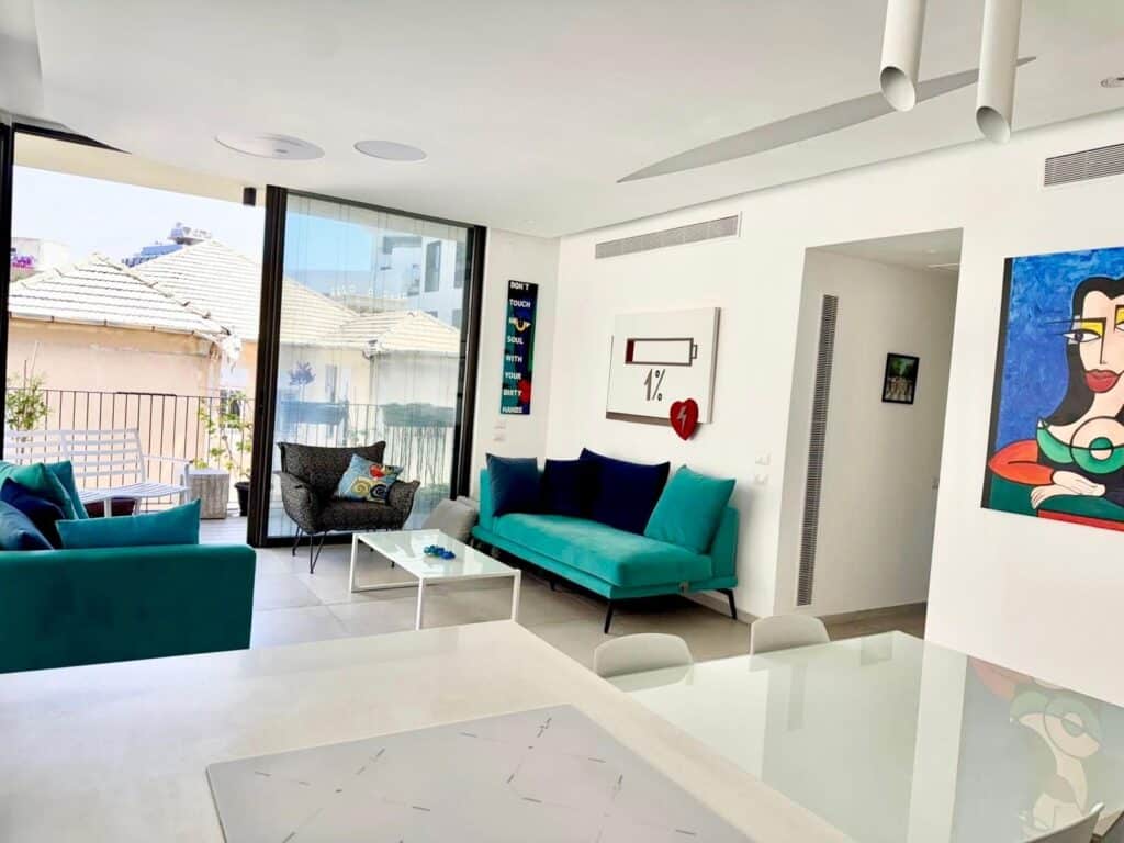 Sunny living room with balcony access in Tel Aviv apartment