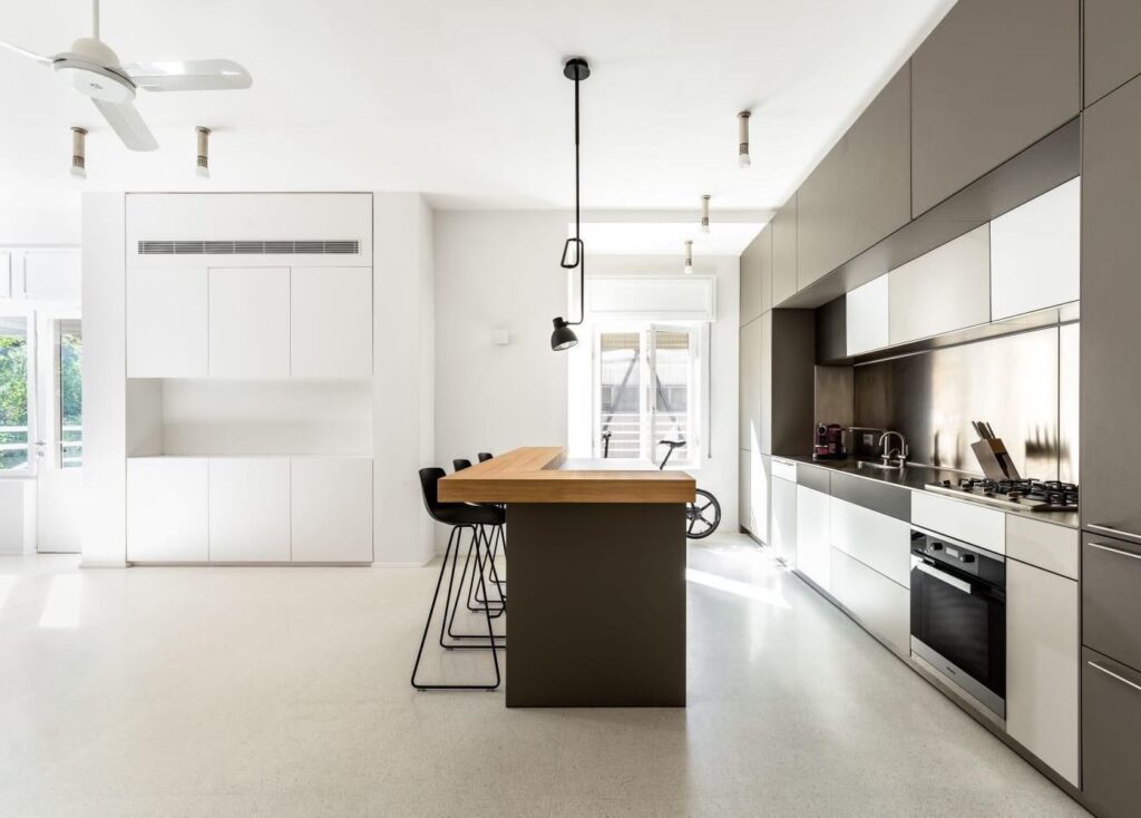 Open-plan kitchen and dining area with natural light and minimalist design