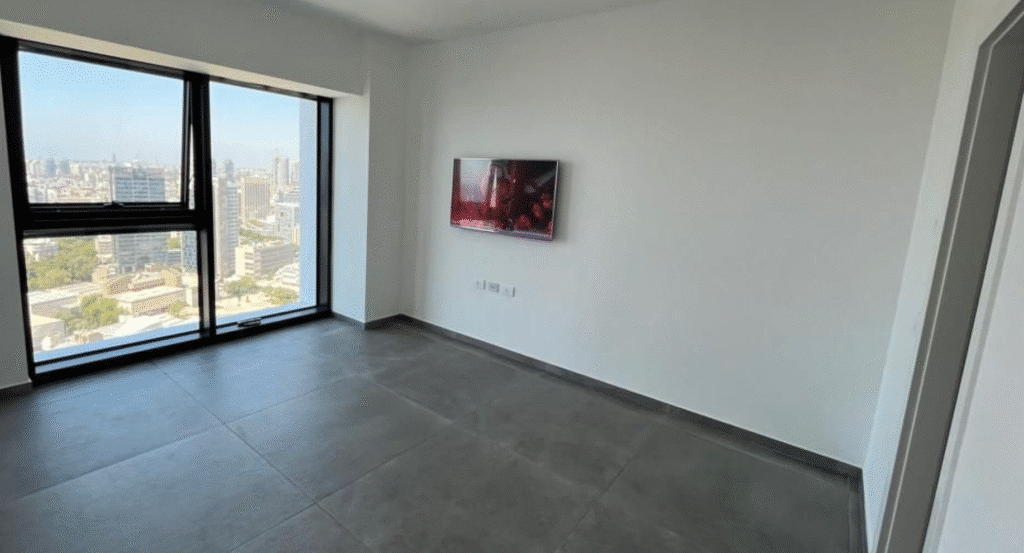 Bright modern living room with city views and wall-mounted TV