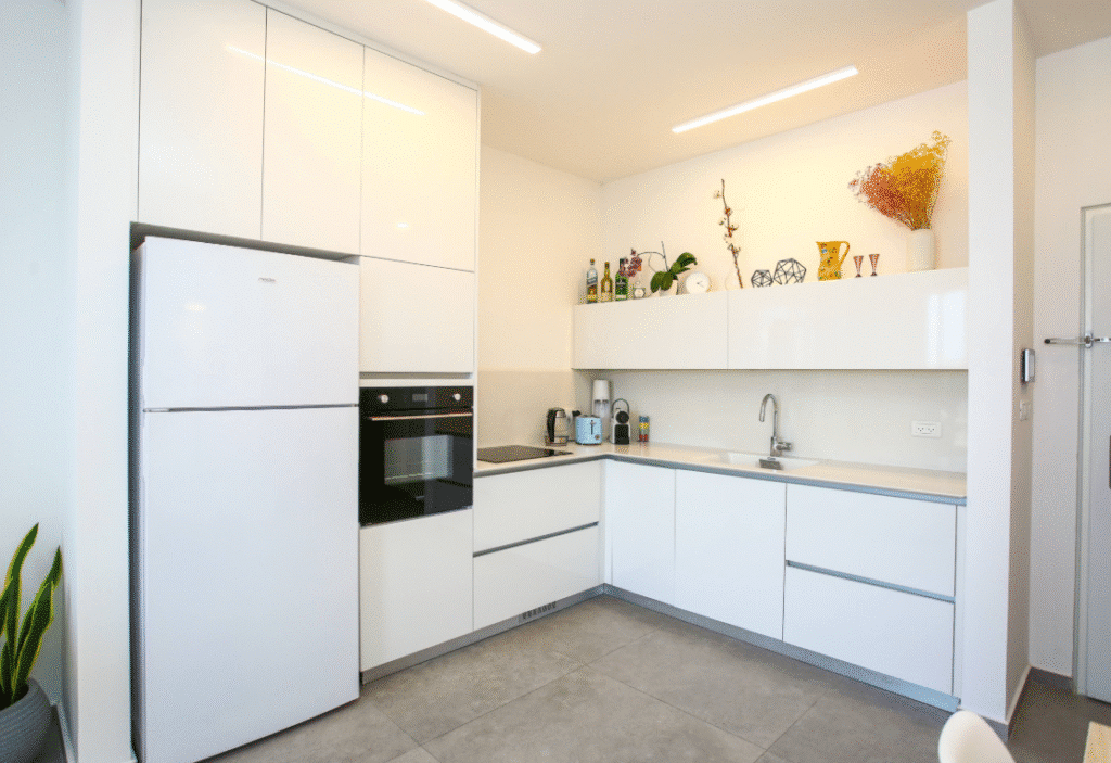 Fully equipped kitchen with oven, cooktop, and dishwasher