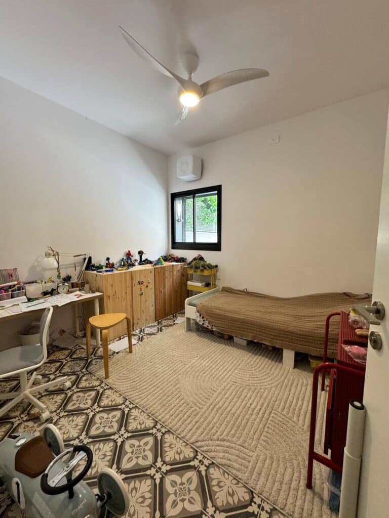 Bedroom with decorative tiled floor in Tel Aviv apartment