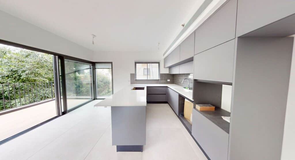 Modern open kitchen with natural light and balcony access