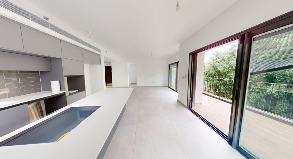 Bright living area with large windows and balcony doors