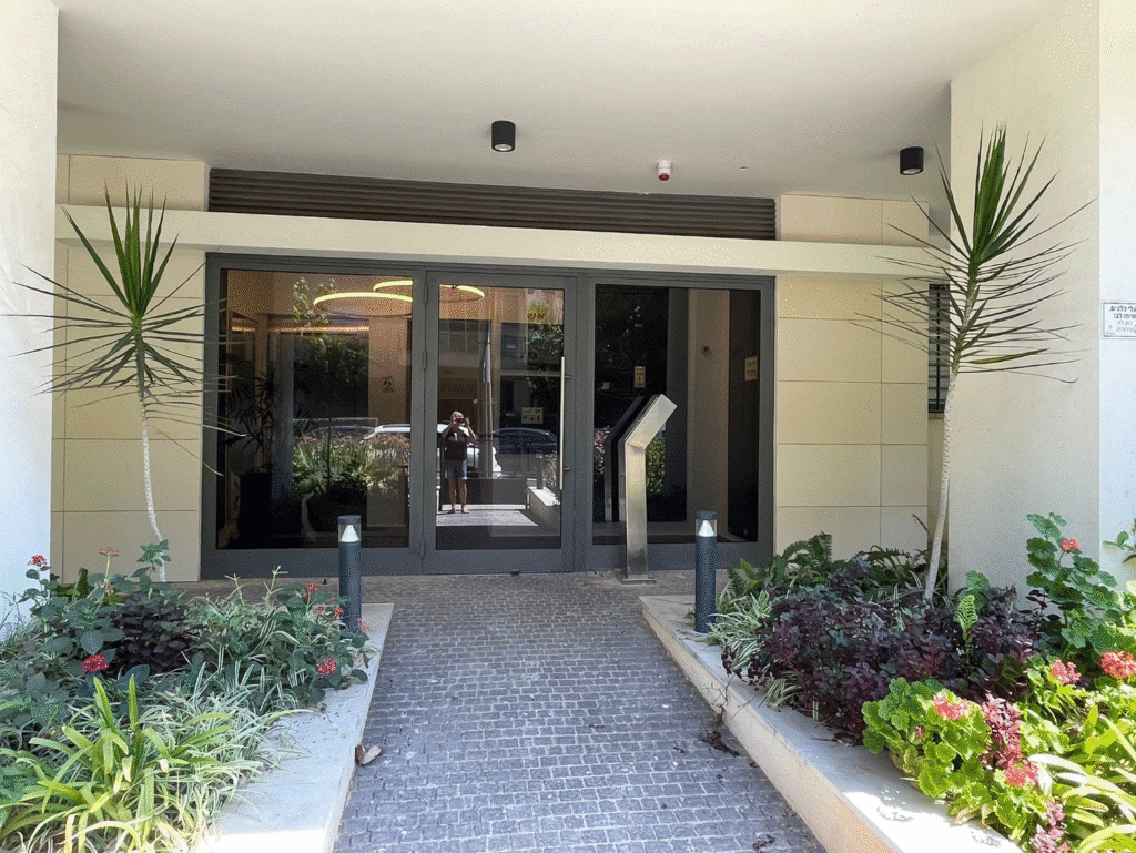 Renovated building entrance with modern landscaping in Tel Aviv